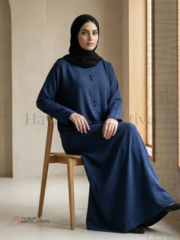 Stylish navy blue silk abaya worn by model in studio perfect for formal events and modest fashion