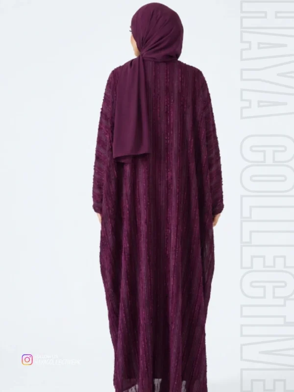 Back view of the Luxury Deep Plum textured abaya highlighting premium craftsmanship, flowing maxi length, and elegant modest fashion by Haya Collective.